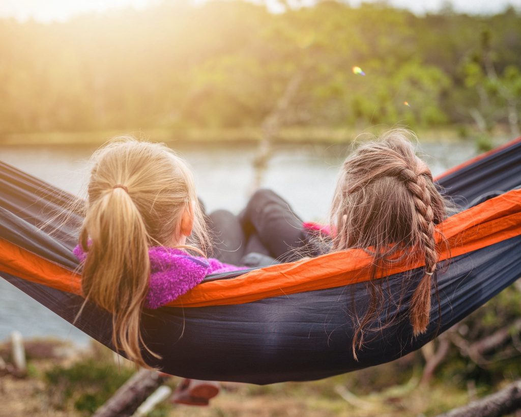 Two girls hammocking